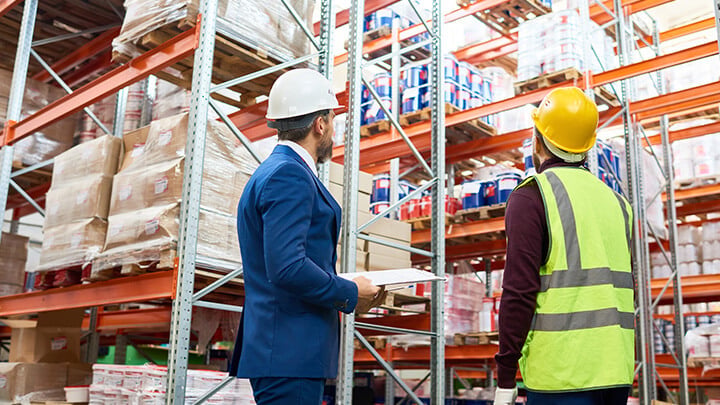 Warehouse staff and management in conversation