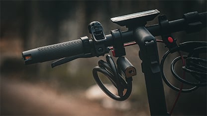 A close up of the steering rack of an electric scooter